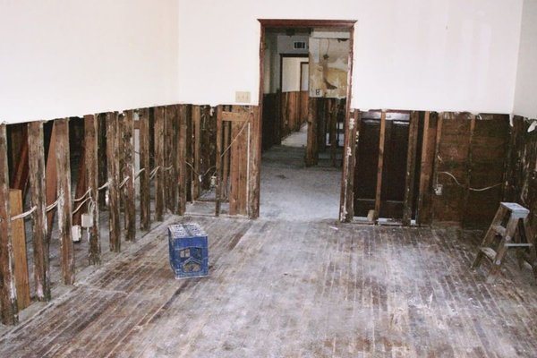 Flood damage cleanup crew removing water from an El Paso, TX hallway