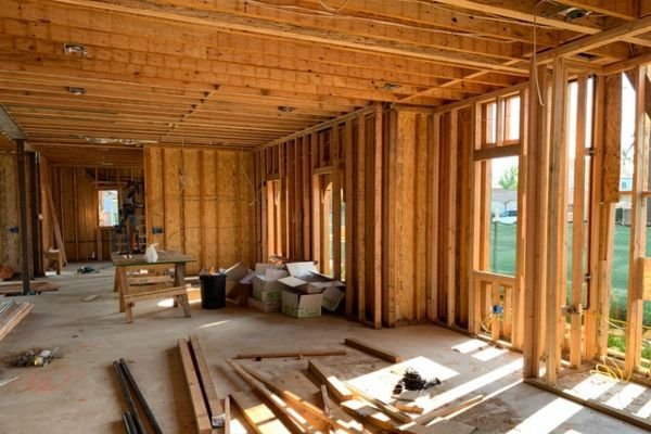 Contractor repairing water-damaged drywall in an El Paso, TX home